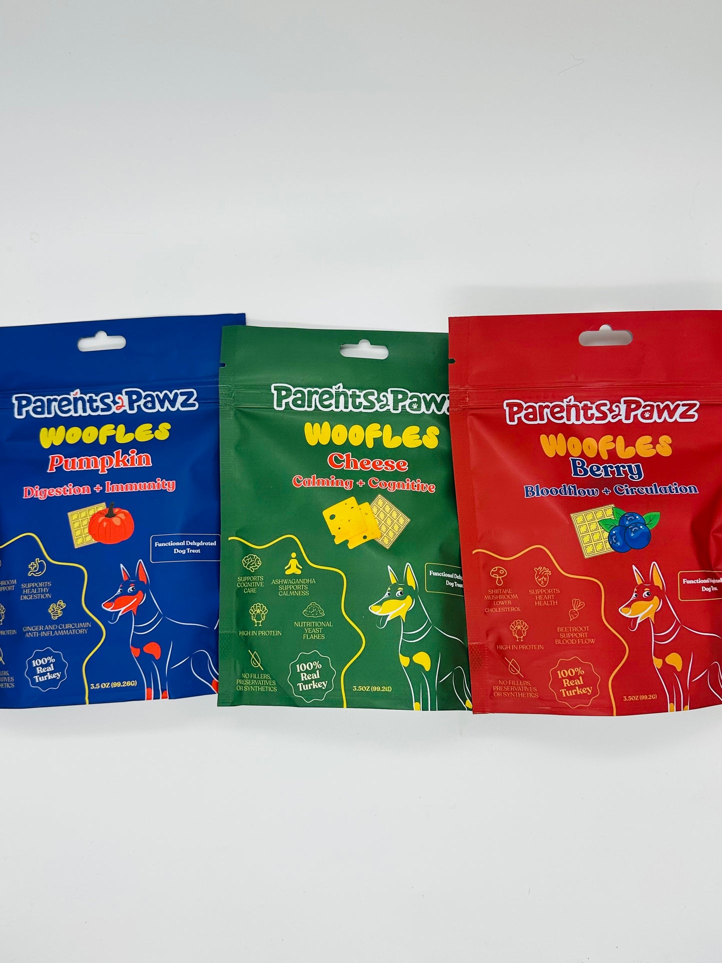 Three packages of Pawesome Treats on a white background